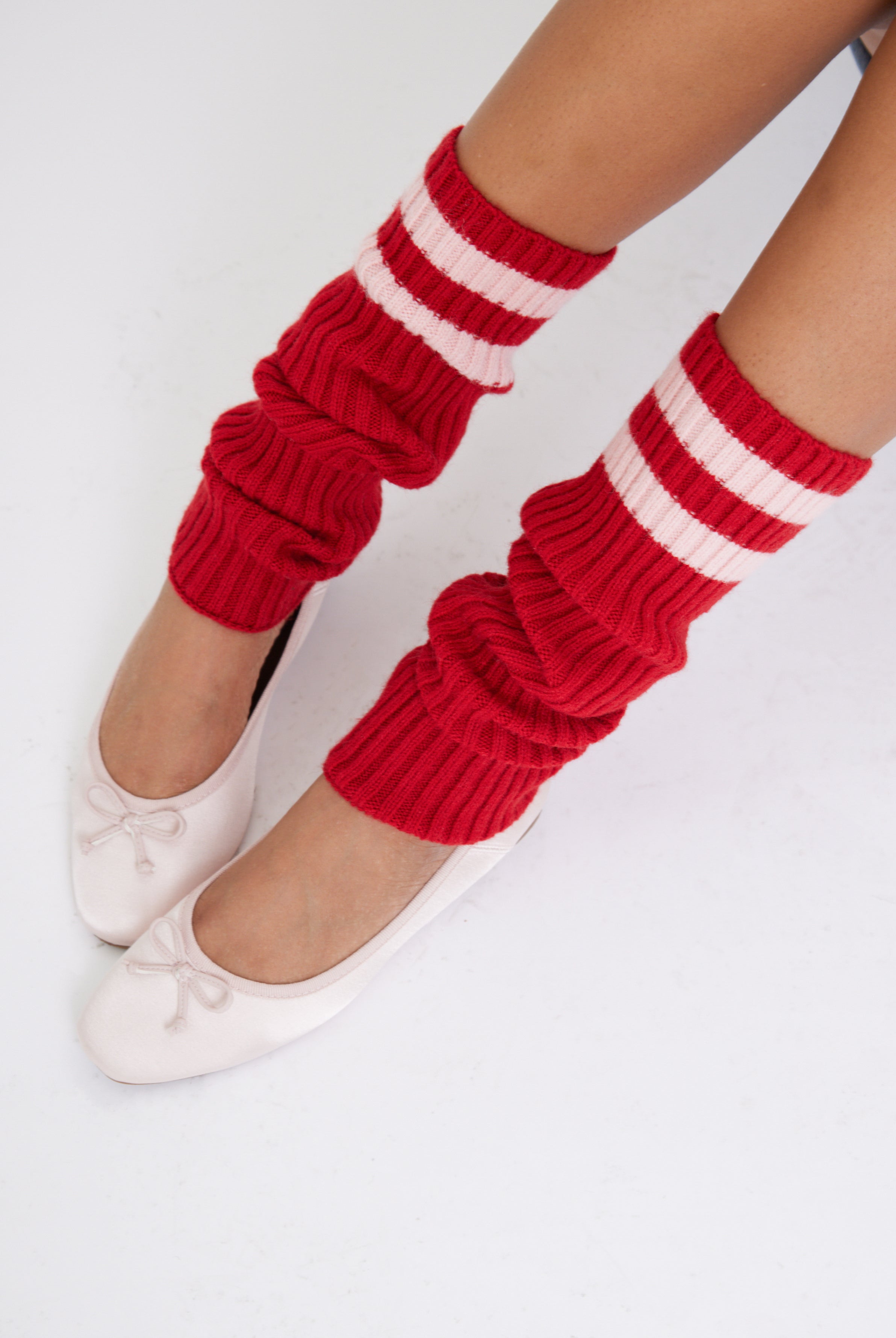Women's knitted leg warmers in red with pink stripe