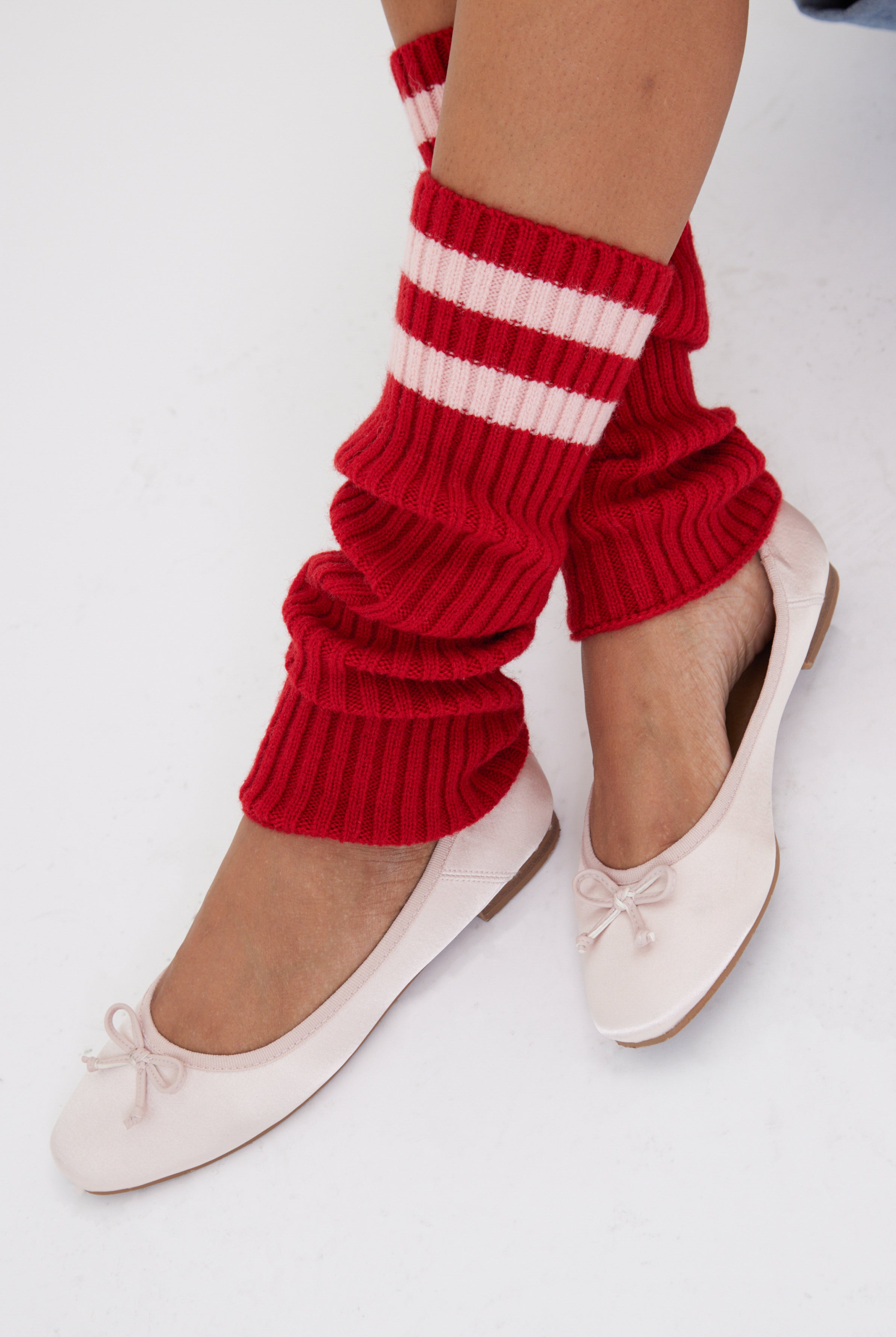 Women's knitted leg warmers in red with pink stripe