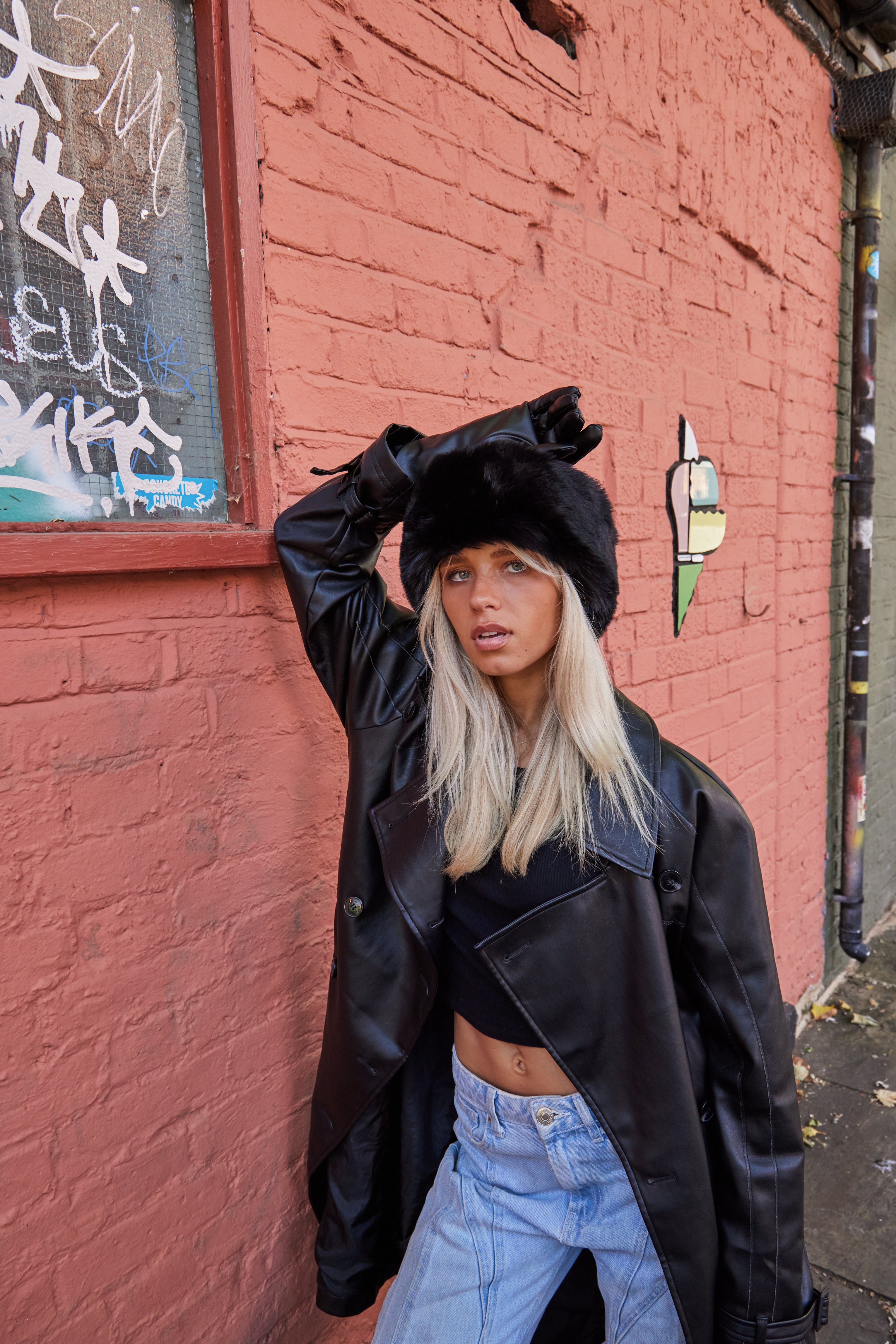 Girl wearing black fur headband and black leather gloves